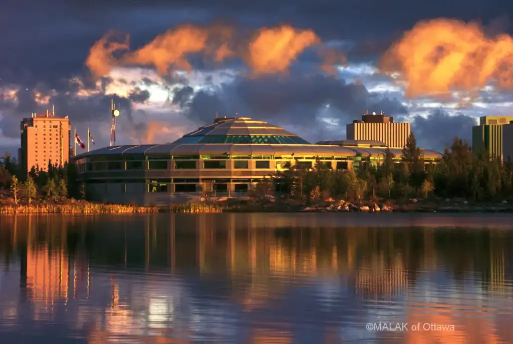 Modern Malak of Ottawa building at sunset reflecting on the water.