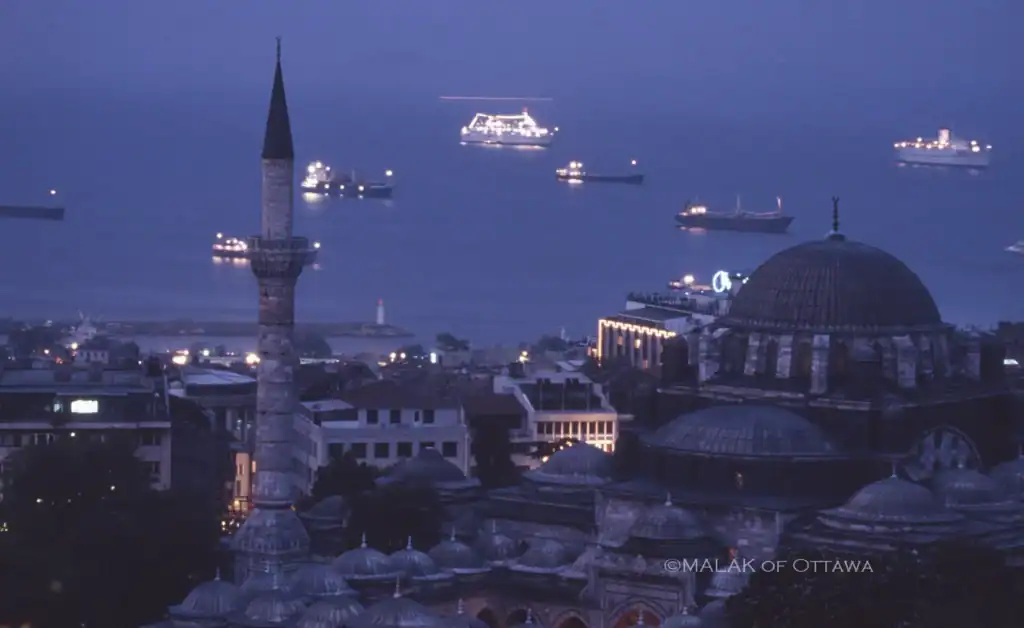 Bosphorus Strait view from Istanbul with illuminated ships and historic skyline.