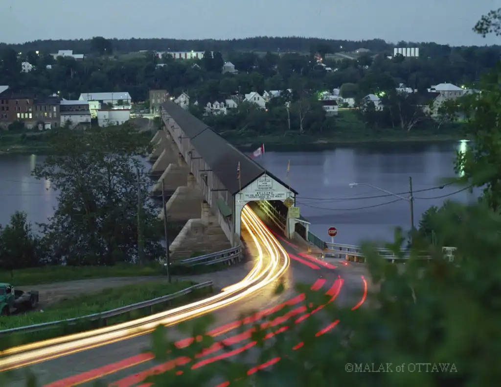 Bridge over Ottawa River with light trails from moving vehicles.