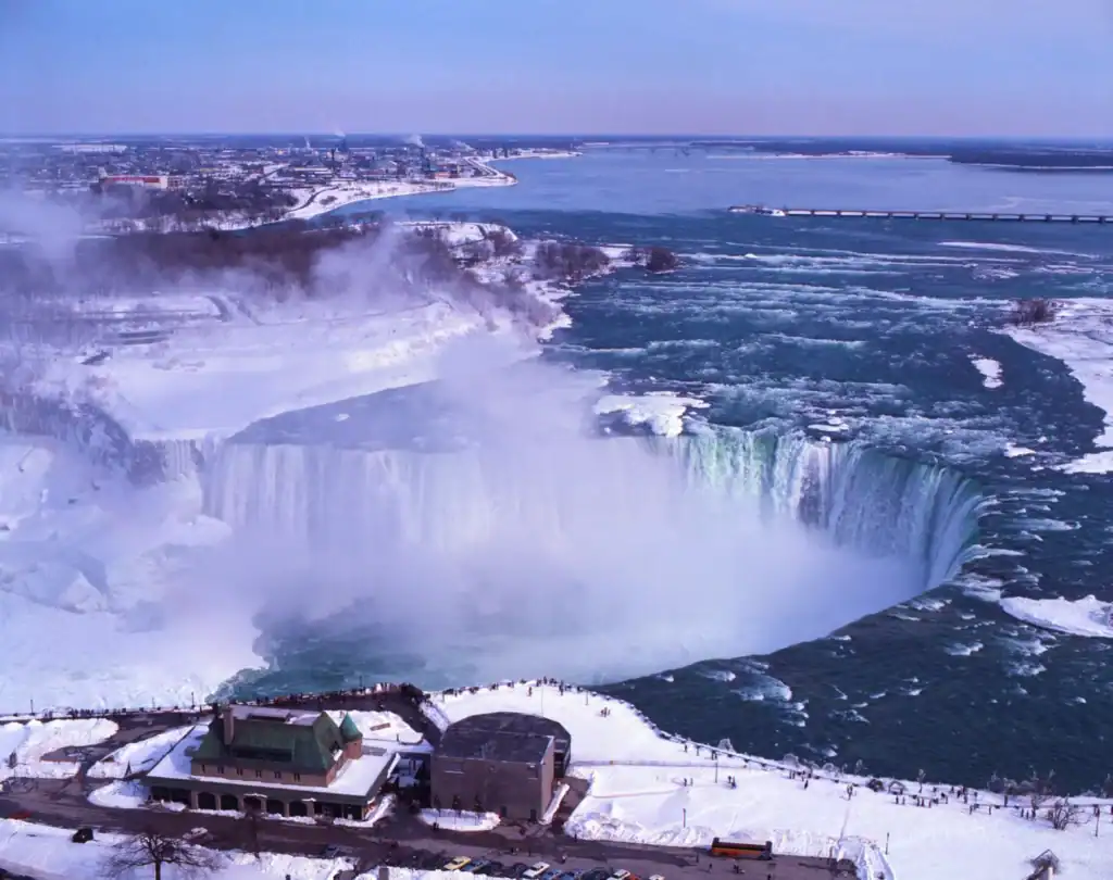 Iconic Niagara Falls covered in snow and ice during winter.