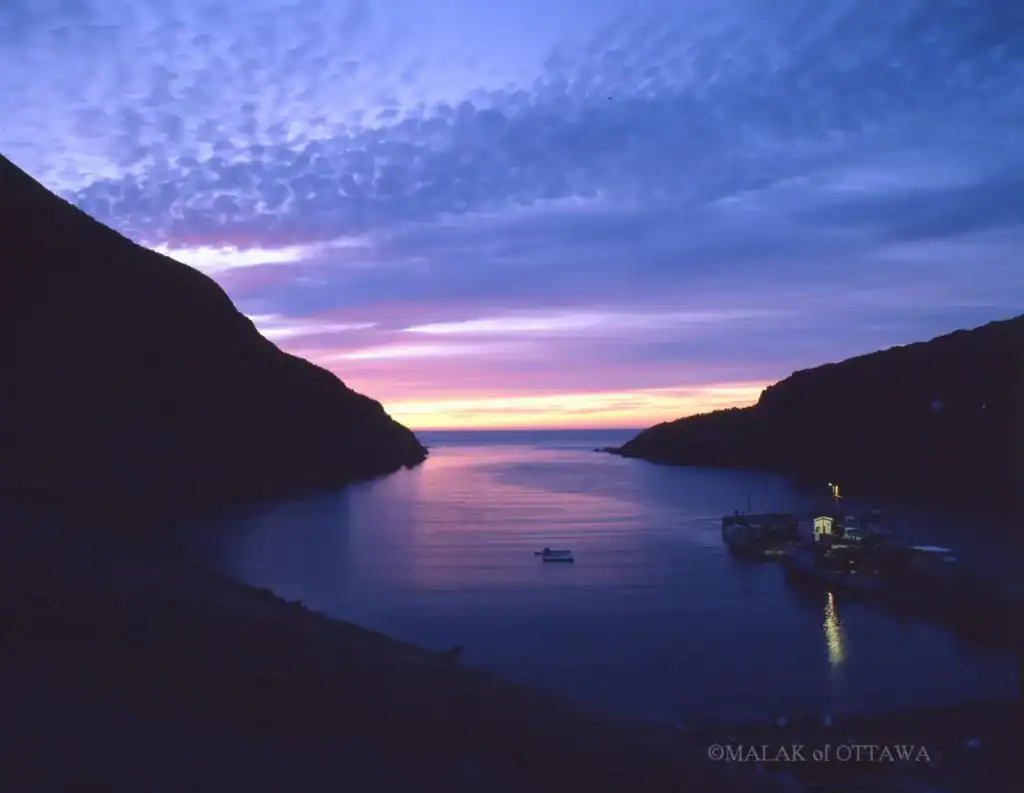 Ottawa River at sunset with colorful sky and calm waters, showcasing natural beauty and tranquility.