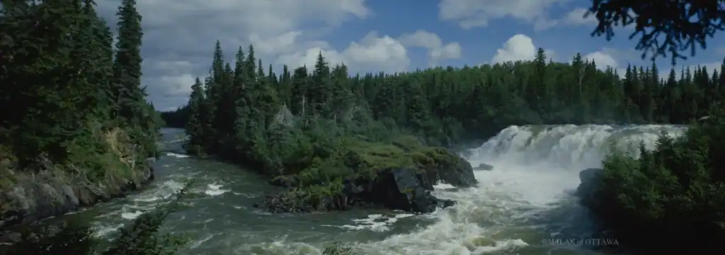 Scenic view of Malak of Ottawa waterfall surrounded by lush greenery.