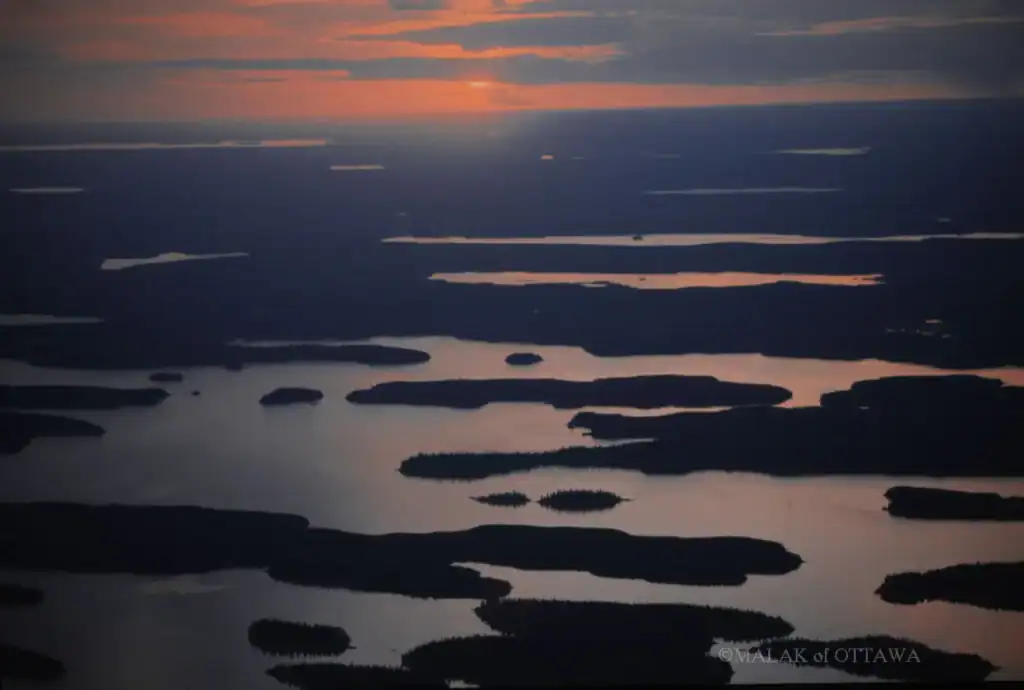 Sunset view of Ottawa lakes with islands and water reflections.