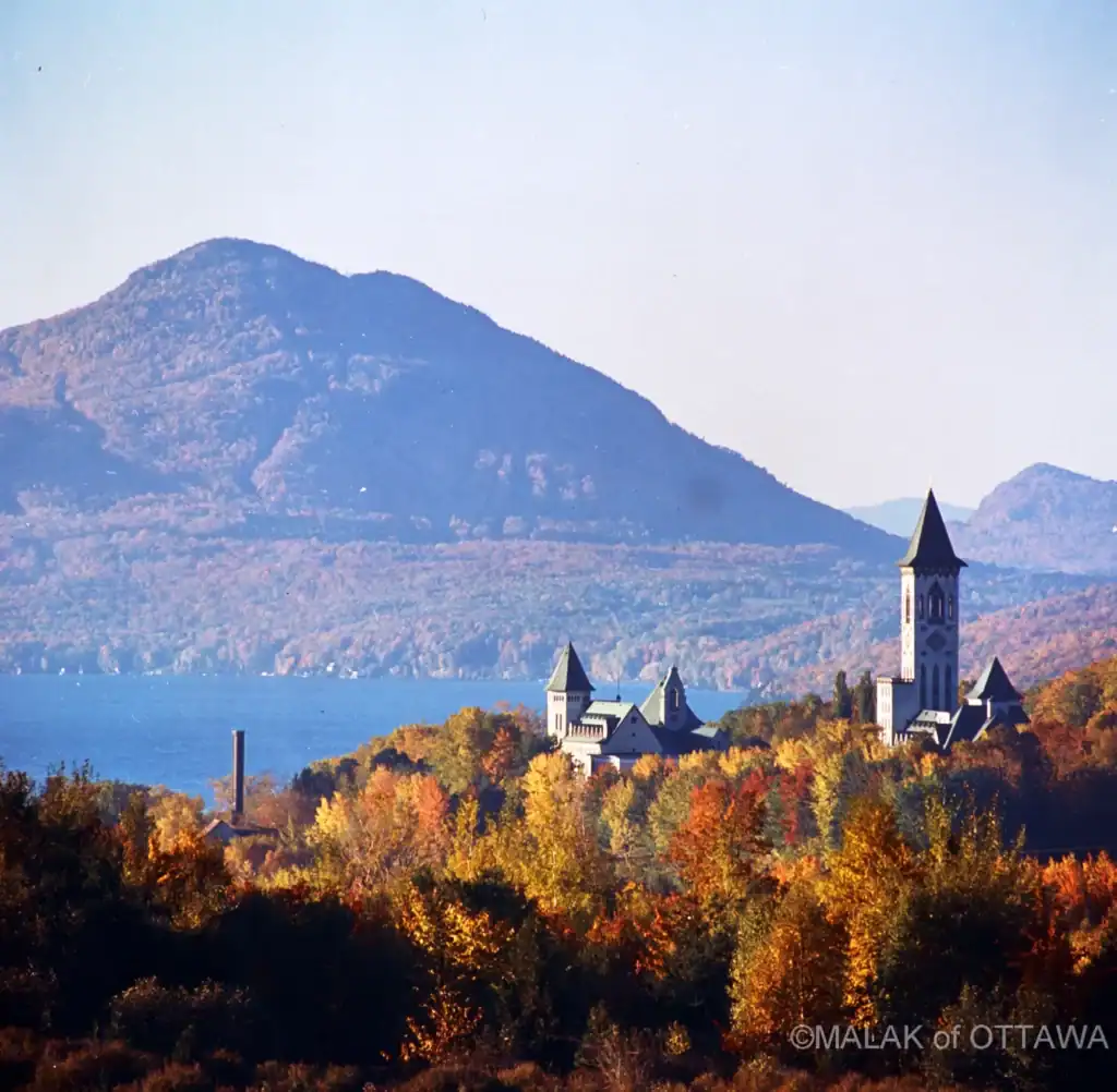Scenic view of a mountain, lake, and historic church in Ottawa during autumn. Perfect for travel and.