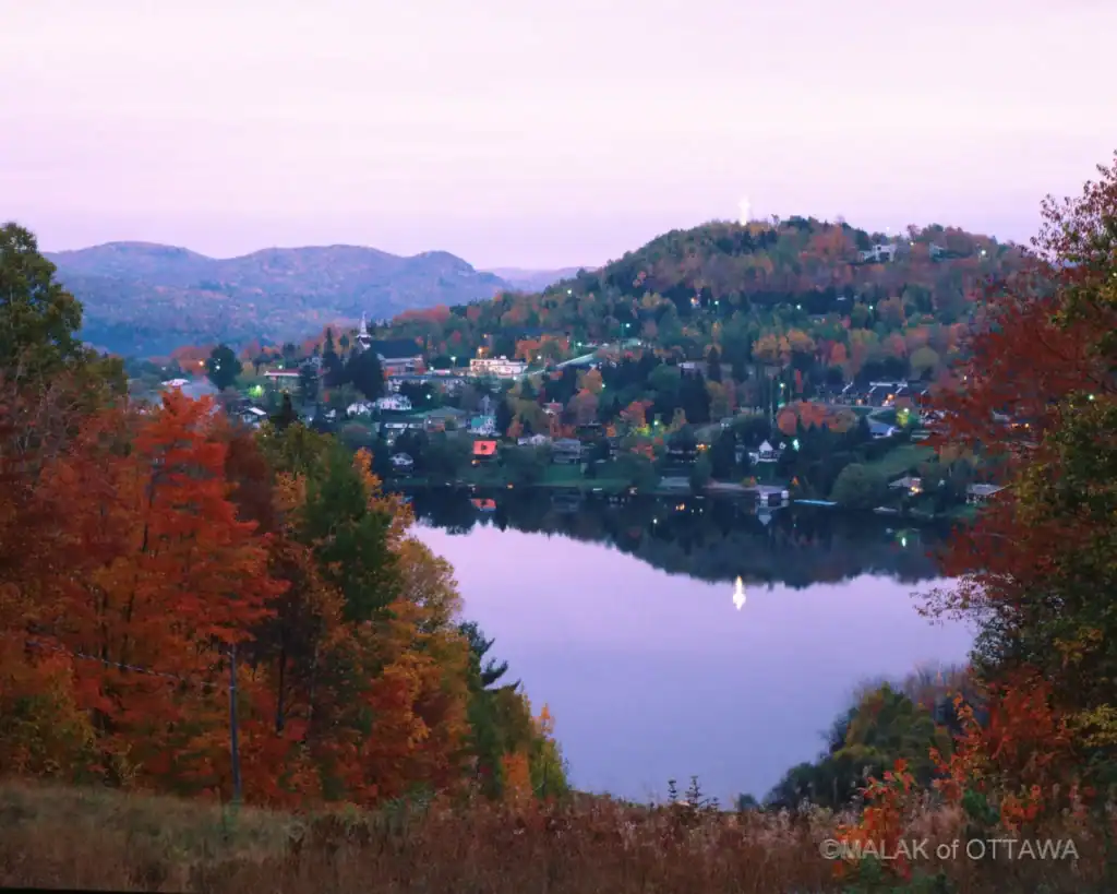 Scenic view of Ottawa's river surrounded by colorful autumn trees and hills.