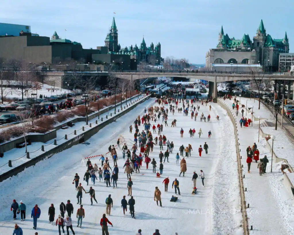 People ice skating on Rideau Canal in Ottawa winter scene.