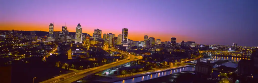 Ottawa city skyline with vibrant sunset colors and illuminated buildings.
